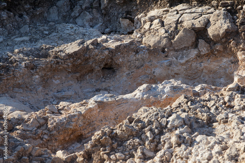 Rocky terrain with uneven surfaces and various textures. Natural geological formations create a rugged landscape