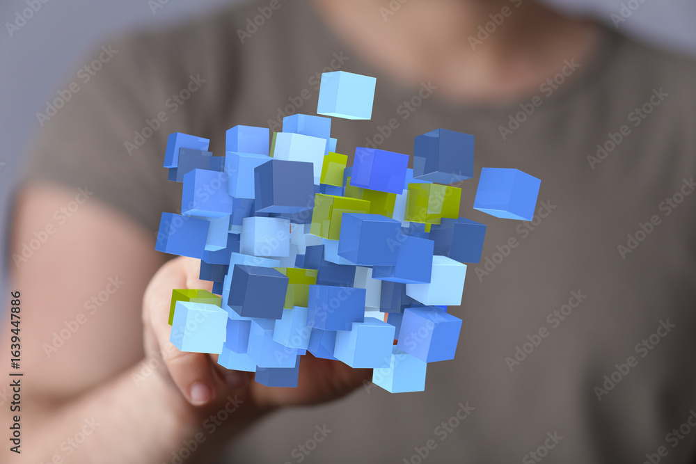Person holding digital blue and yellow cubes. Abstract data concept. Person holding digital blue and yellow cubes. Abstract data concept.