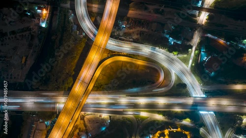 Time lapse of night scene at busy street light trail aerial view. 