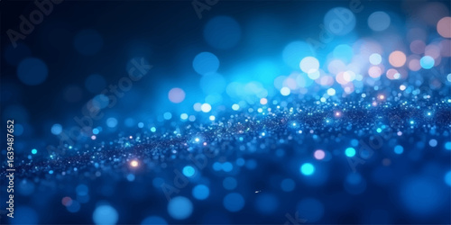 Abstract bright blue background with defocused glitter and glowing circles creating a festive holiday bokeh pattern