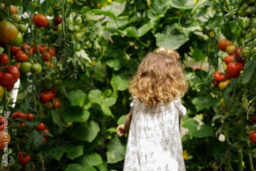 A toddler explores a lush g...