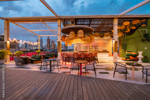 Contemporary roof top bar and cityscape view at twilight.