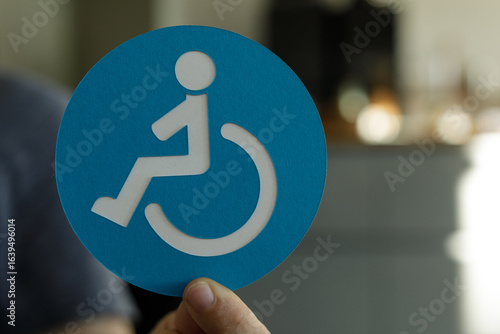 Person holding a blue circl...
