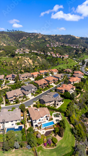Aerial view luxury homes with hillside.