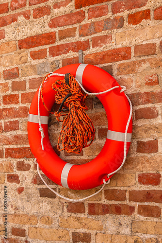 Orange Lifebuoy Hanging On The Wall Besides River Isar