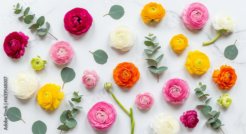 Vibrant assortment of ranunculus flowers and eucalyptus leaves