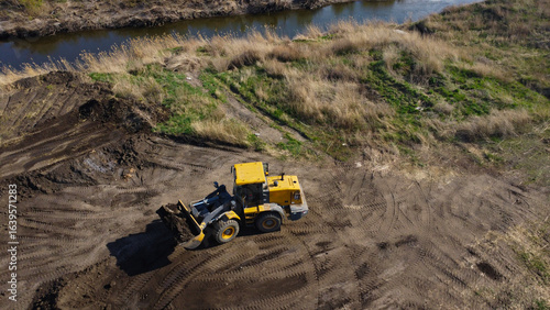 Aerial View of a Yellow Loader Working on Land Development