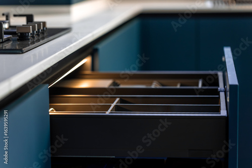 Pull out cutlery organizer. LED drawer lighting. Blue minimal kitchen