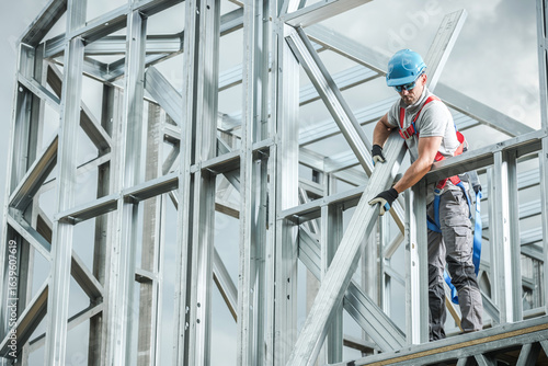 Construction Worker Assembling Metal Framework on Building Site During Daylight
