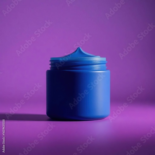 An open blue cream jar with a textured swirl of cosmetic product on a vibrant purple background.