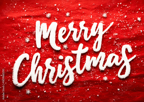 Festive Merry Christmas greeting with snowflakes on red background