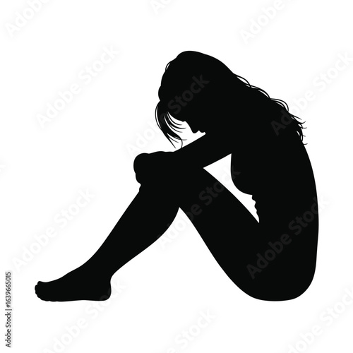 Silhouette of a woman in distress sitting and crying