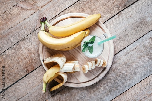 Fresh Bananas and Banana Smoothie on Wooden Table