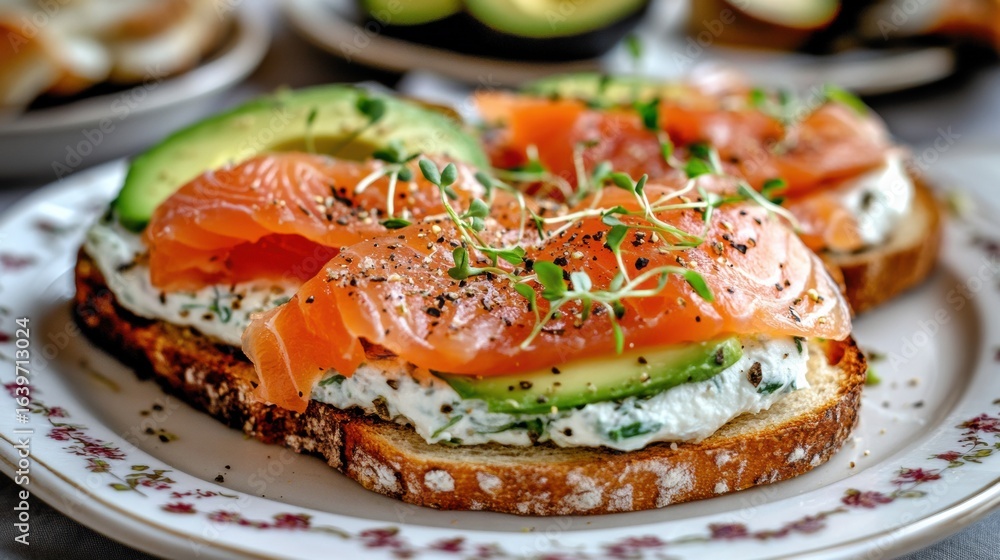 Delicious plate of smoked salmon and cream cheese-topped toast with Avocado Delicious plate of smoked salmon and cream cheese-topped toast with Avocado