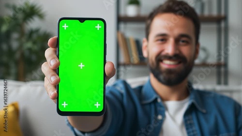 Man showing smartphone with chroma key screen for app promotion mobile device digital technology