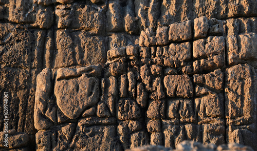 Brown sea rock eroded by waves