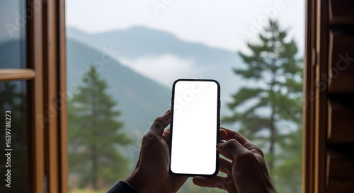 Blank screen smartphone held by hands scenic mountain view travel mockup technology mobile phone display app website design advertising template