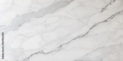 Luxury texture of light gray marble with flowing natural patterns and faint metallic highlights.	