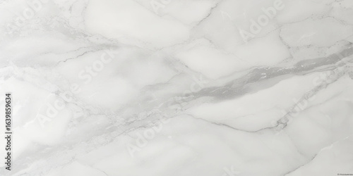 Luxury texture of light gray marble with flowing natural patterns and faint metallic highlights.	