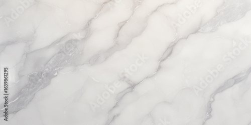 Luxury texture of light gray marble with flowing natural patterns and faint metallic highlights.	