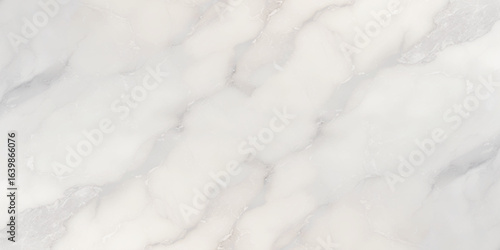Luxury texture of light gray marble with flowing natural patterns and faint metallic highlights.	