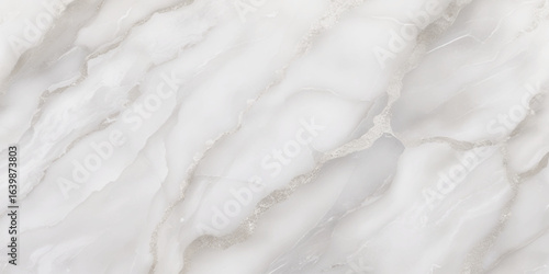 Luxury texture of light gray marble with flowing natural patterns and faint metallic highlights.
