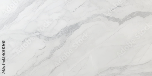 Luxury texture of light gray marble with flowing natural patterns and faint metallic highlights.