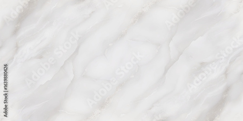 Luxury texture of light gray marble with flowing natural patterns and faint metallic highlights.