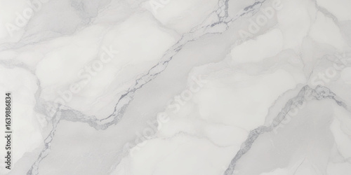 Luxury texture of light gray marble with flowing natural patterns and faint metallic highlights.	