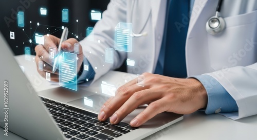 Doctor working on a laptop with digital medical files