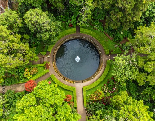 Aerial view of a formal garden with a central pond and fountain