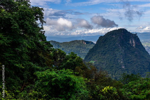 Wallpaper Mural Idyllic landscape with winding river, rolling hills, and mist drifting through pine forests.
Wind-swept trees along a mountain river under dramatic sky with moving clouds. Torontodigital.ca