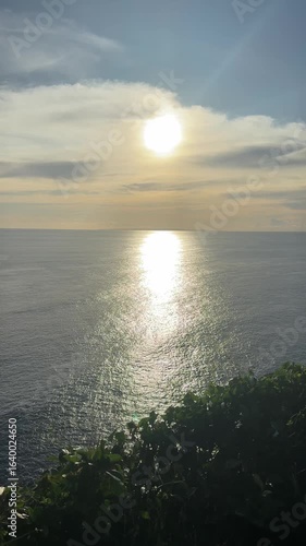 Wallpaper Mural Scenic sunset Cliff View of surface of the ocean in Bali, Indonesia vertical video Torontodigital.ca