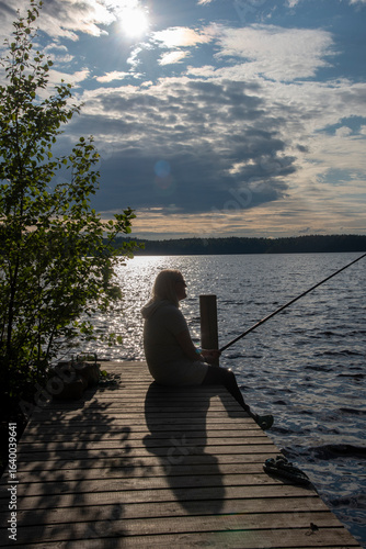 Wallpaper Mural Woman fishing on the pier at evening Torontodigital.ca