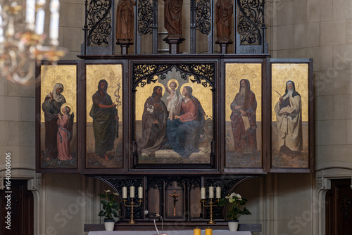 Fototapeta Naklejka Na Ścianę i Meble -  Altar with gilded paintings in a church interior. 
