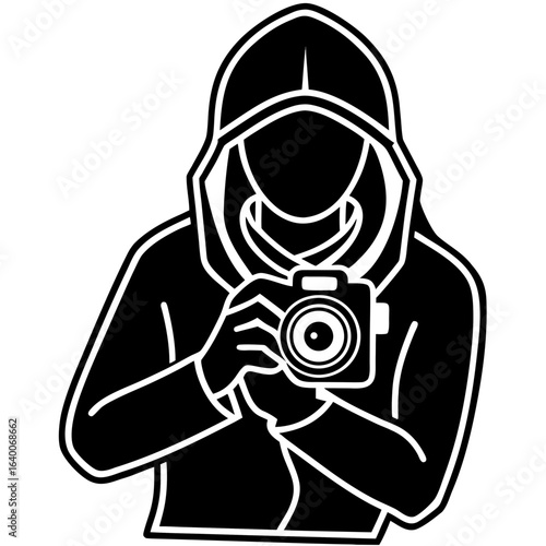 Silhouette of a person in a hood holding a camera