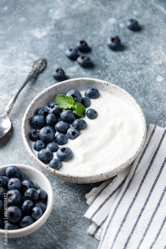 Bowl of greek yogurt with blueberries, blackberries topping. Healthy food diet