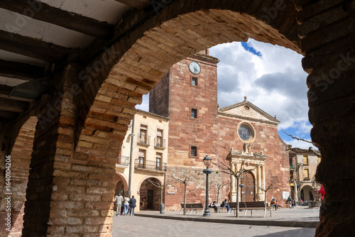 Main square of Prades with the Parish Church of Santa Maria, known as the Red Village for its reddish sandstone buildings, Tarragona, Catalonia, Spain.