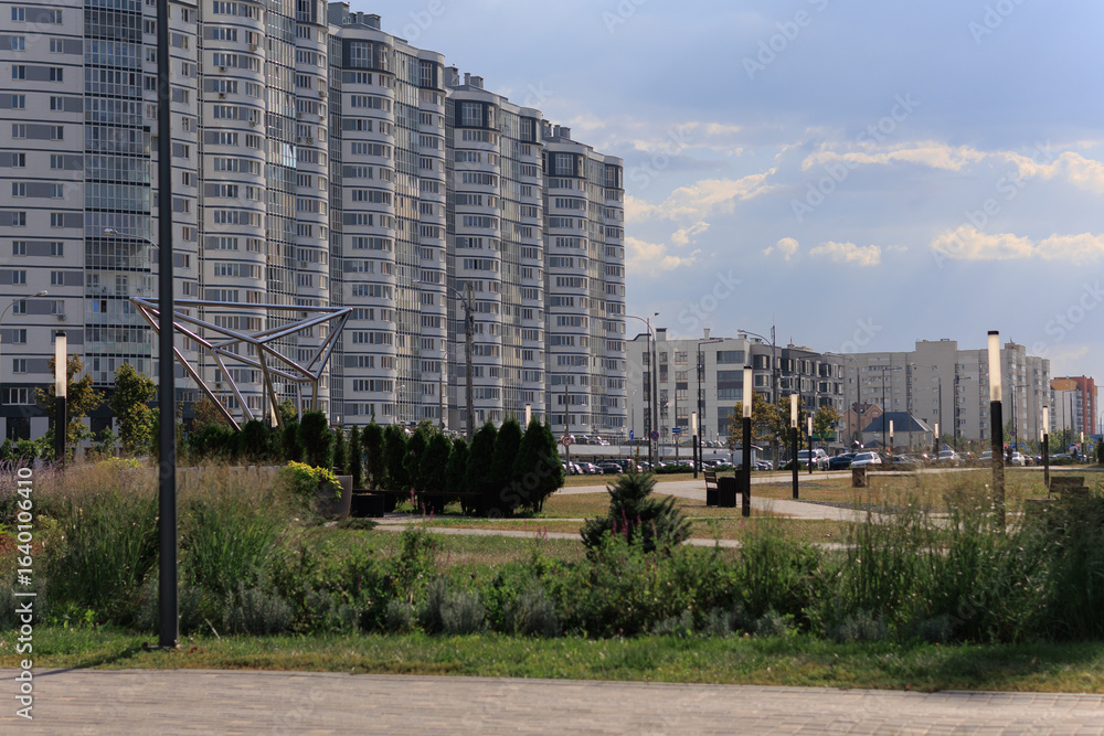 Cityscape on a summer day, modern buildings and houses Cityscape on a summer day, modern buildings and houses