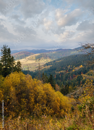 Cloudy morning autumn mountain scene. Peaceful picturesque traveling, seasonal, nature and countryside beauty concept scene.