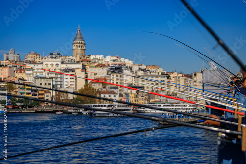 Artistic blurred fishermen on Galata Bridge, popular pastime in Istanbul, Turkey