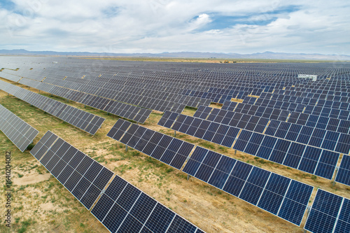 A large field of solar panels is shown in the image