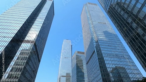 Wallpaper Mural Skyscrapers pierce the sky their mirrored surfaces reflecting the clear blue above in a modern urban landscape Torontodigital.ca