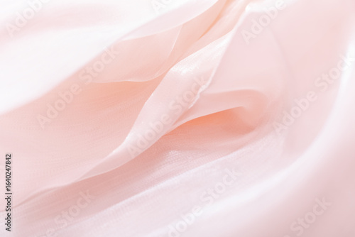 Close-up of soft flowing pink fabric with delicate folds and translucent texture, ideal for backgrounds, fashion branding, wellness visuals, romantic themes, and elegant minimalist compositions