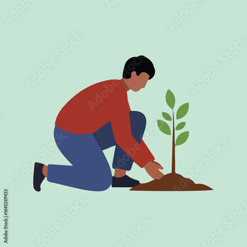 A man kneels while planting a young tree, placing soil around it with his hands, against a light green background.