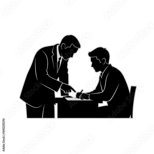 A manager in a suit stands and points at a document, instructing an employee sitting at a desk.
