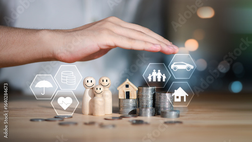 Financial family planning concept with coins, wooden figures, and insurance icons under protective hand, symbolizing budgeting, future savings, financial security, and protection of health and assets.