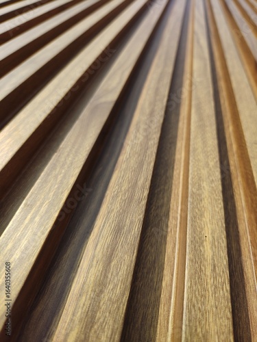 Close-up of wooden slats with a geometric pattern, ideal for backgrounds, architectural design elements, and natural wood texture projects, Close-Up of Brown Wood Striped Texture.