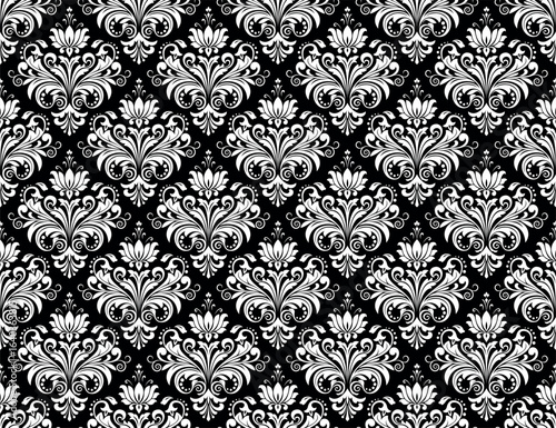 Wallpaper in the style of Baroque. Seamless vector background. White and black floral ornament. Graphic pattern for fabric, wallpaper, packaging. Ornate Damask flower ornament.