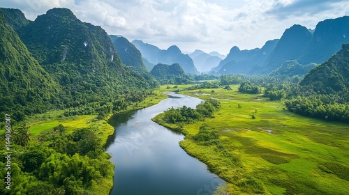 Lush green mountains rising above a quiet river in the valley below, the water reflecting the vibrant colors of the surrounding nature, real photo, stock photography.
